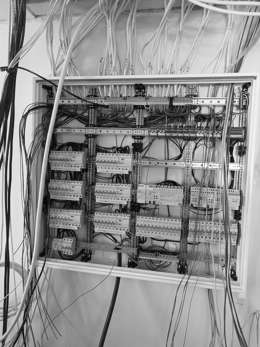A finished consumer unit with the wiring bundled and the circuits labelled.