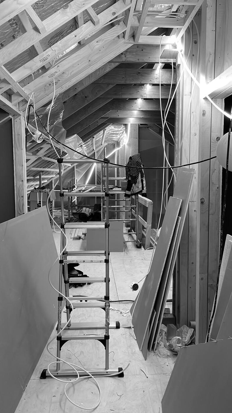 Cable runs across the attic roof trusses during a renovation.