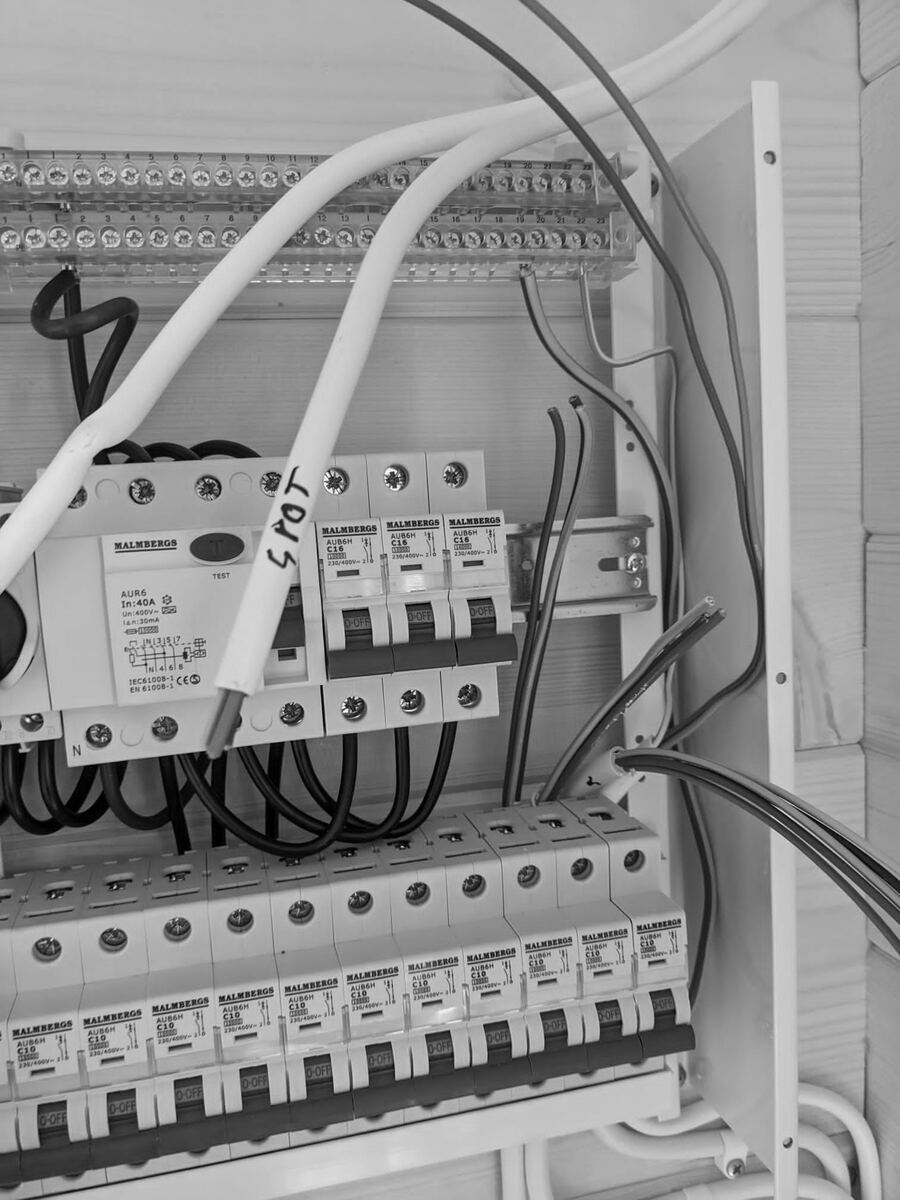 Close-up of a residual current device and circuit breakers in a board.